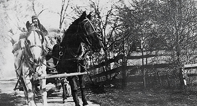 Old-School Original—Farmer John Efflant, driving his horse-drawn wagon on Kotz Road, which was renamed Sunset Ridge Road in the mid-1920’s after Sunset Ridge Country Club came to town. Kotz Road was a dirt road until 1925, when it was finally paved.