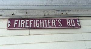 A sign in the backyard of proud retired fireman Louie Dini, who spent three decades on Northfield’s force.